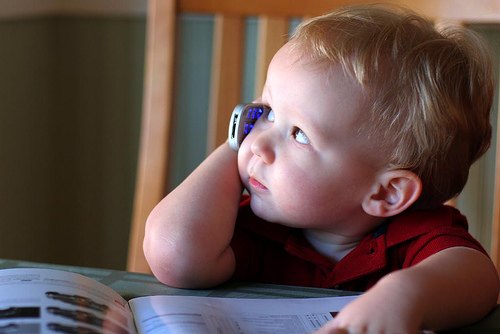 Toddler holding a mobile phone to his ear